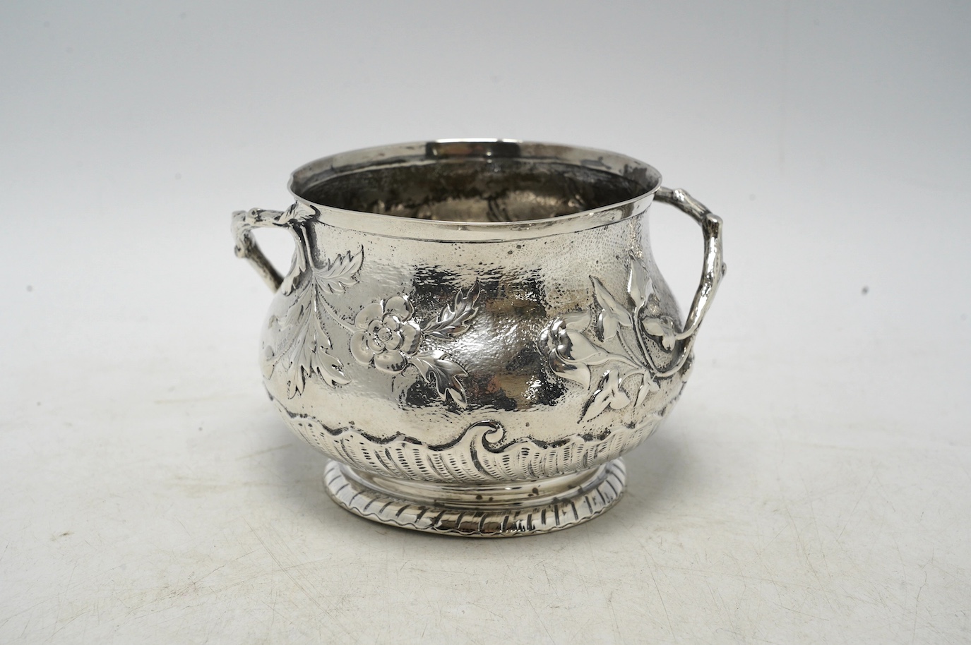 A late Victorian silver two handled sugar bowl, by Carrington & Co, London 1900, 7.3oz. Condition - poor to fair